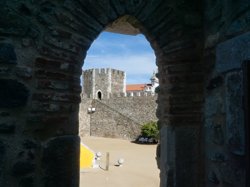 Beja castle courtyard seen through a brick arch
