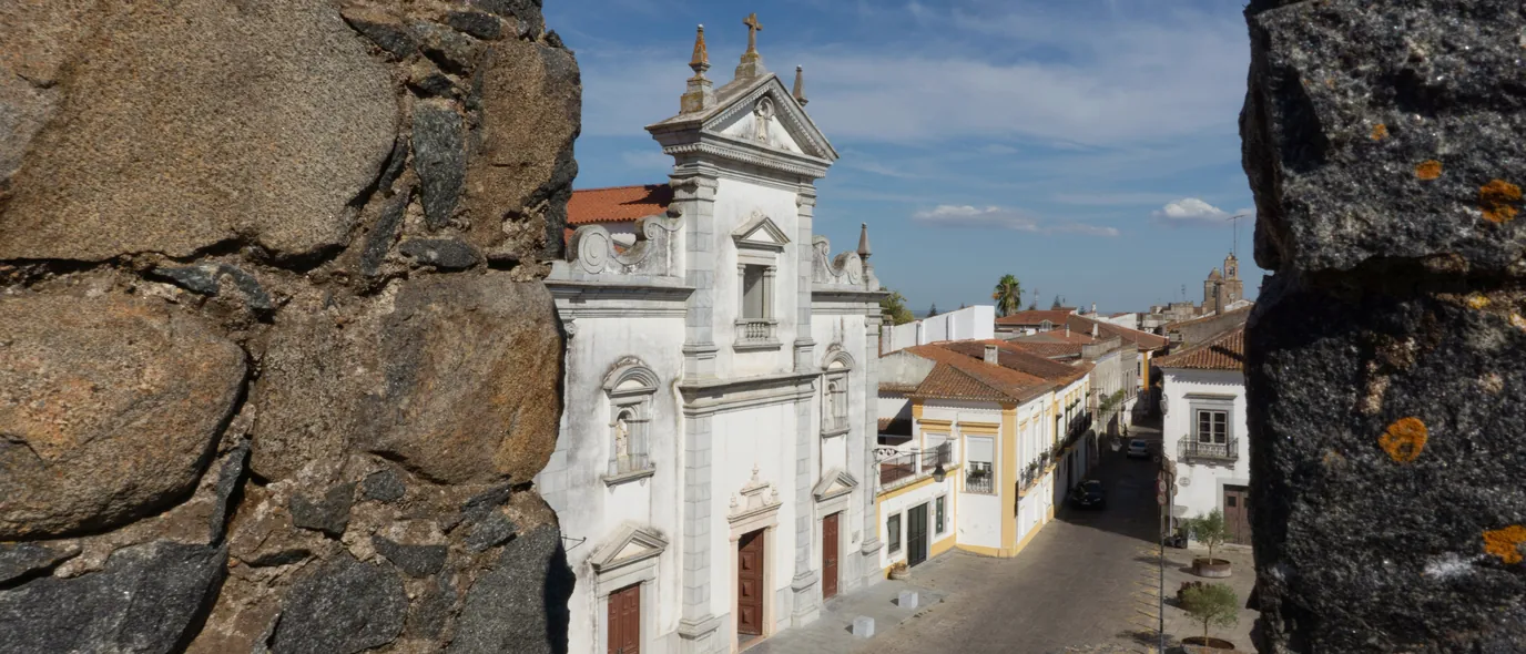 The Sé Cathedral and the lower town seen through the castle battlements